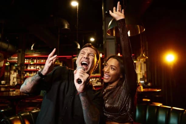 Generic stock atmosphere: two people singing into a microphone, not this event or venue