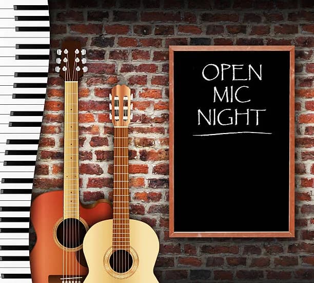 Generic stock atmosphere: guitars, piano keys and an Open Mic Night chalkboard, not this event or venue